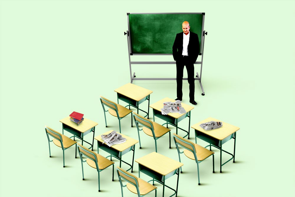 A teacher with empty desks